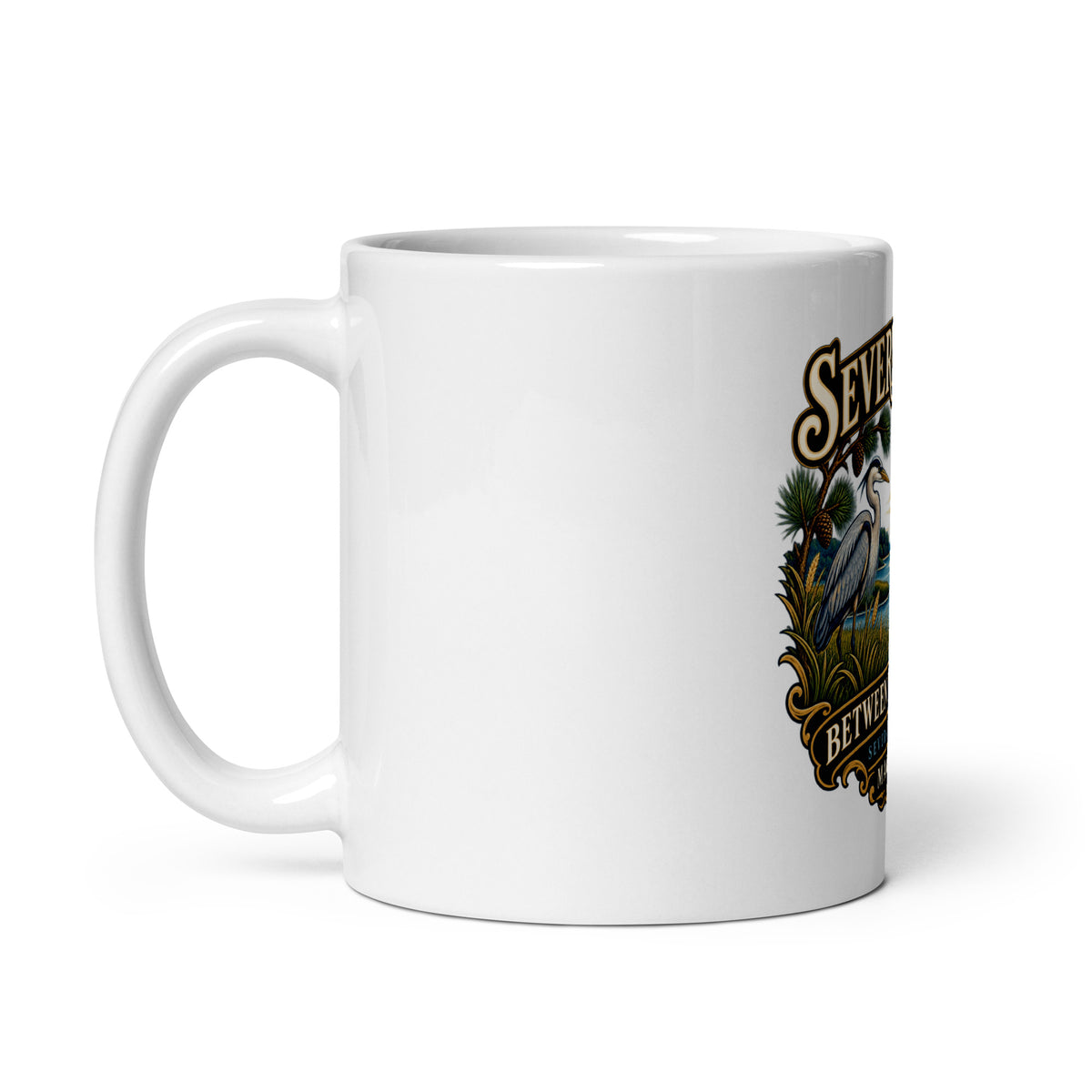 Handle on left: Severna Park Between Two Rivers sailboat and heron artwork with Severn and Magothy lettering on coffee mug