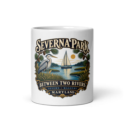 Front view: Severna Park Between Two Rivers sailboat and heron artwork with Severn and Magothy lettering on coffee mug